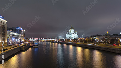 Majestic orthodox Cathedral of Christ Saviour illuminated at dusk on bank of Moscow river. Timelapse hyperlapse, Russia