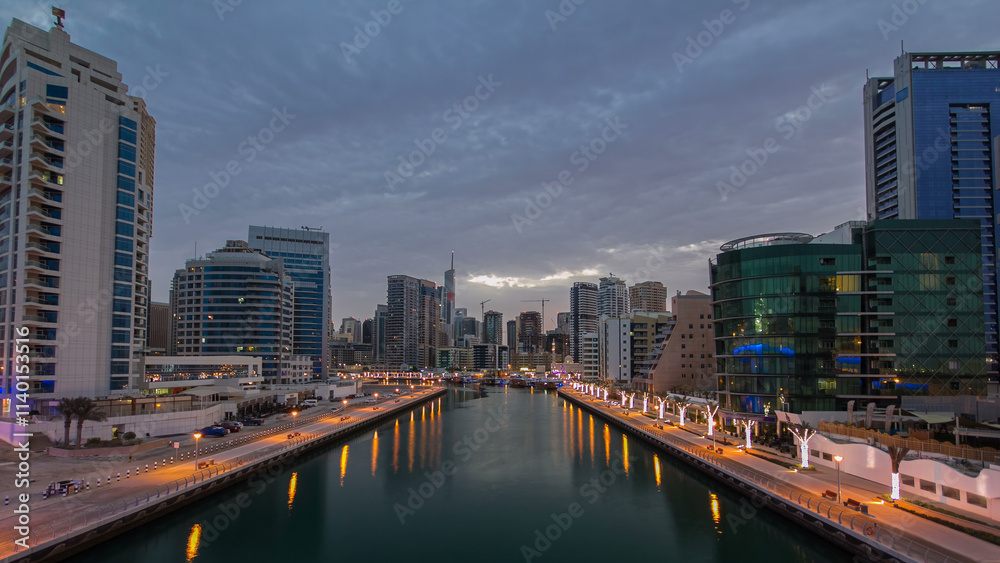 Dubai Marina towers and canal in Dubai night to day timelapse Dubai Marina towers and canal in Dubai night to day timelapse