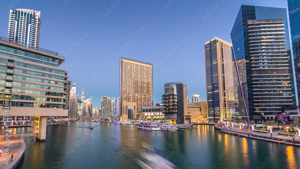 Fototapeta premium Dubai Marina towers and canal in Dubai day to night timelapse