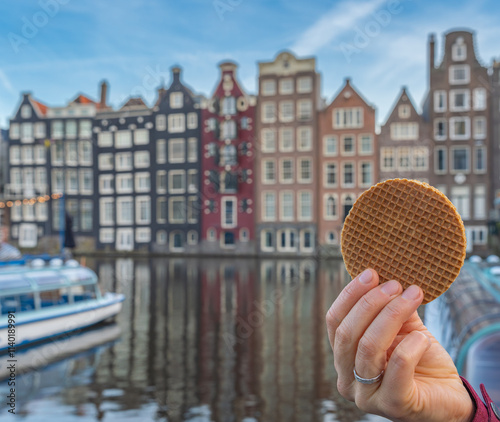 Photography Traditional dutch Stroopwafel in front of picturesque houses in Amsterdam