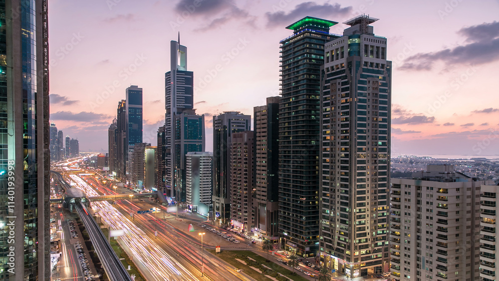 Fototapeta premium Downtown Dubai towers day to night timelapse. Aerial view of Sheikh Zayed road with skyscrapers after sunset.