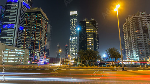 Downtown Dubai towers night timelapse hyperlapse. View of Sheikh Zayed road with tall skyscrapers. photo