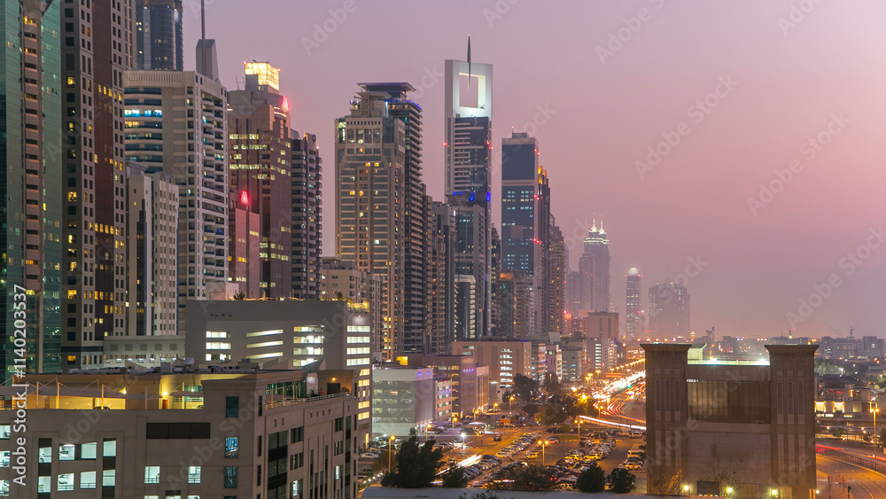 Downtown Dubai towers day to night timelapse. Aerial view of Sheikh Zayed road with skyscrapers after sunset. Downtown Dubai towers day to night timelapse. Aerial view of Sheikh Zayed road with skyscrapers after sunset.