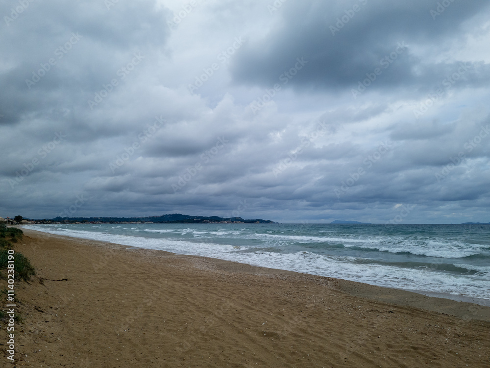 Gloomy beach with waves and cloudy sky Gloomy beach with waves and cloudy sky