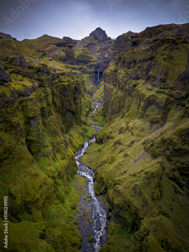 Beautiful rugged landscape at Mulagljufur canyon with cascading waterfalls, river and mossy rocks in Iceland photo