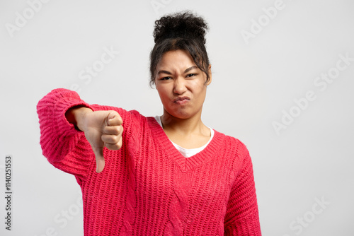 Konstfotografi Young woman showing thumbs down gesture expressing dislike