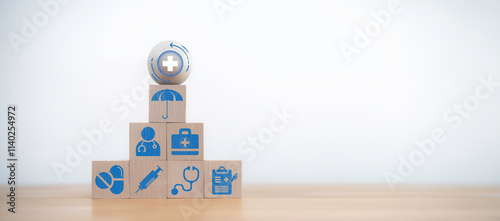 Health concept with wooden blocks stacked as a pyramid. Each block displays medical icons like stethoscope, syringe, and pills, symbolizing healthcare, treatment, and medical support photo