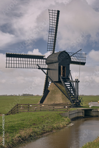 Traditional Dutch Spinnenkop Windmill near Nijhuizum, Friesland, Netherlands photo