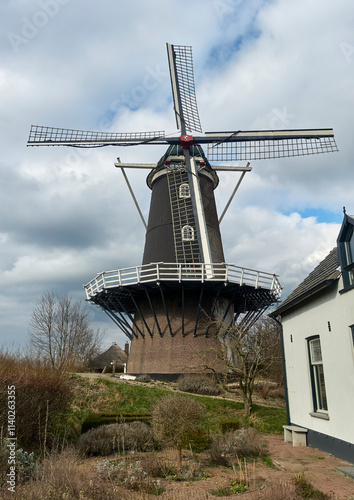 Historic Windmill De Blauwe Reiger in Haaften, Dutch River Landscape photo