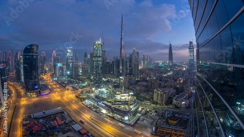 Dubai Downtown night to day timelapse. Aerial view over big futuristic city by night. photo