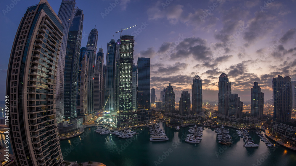 Obraz premium Aerial view of modern skyscrapers night to day timelapse before sunrise in Dubai Marina in Dubai, UAE.