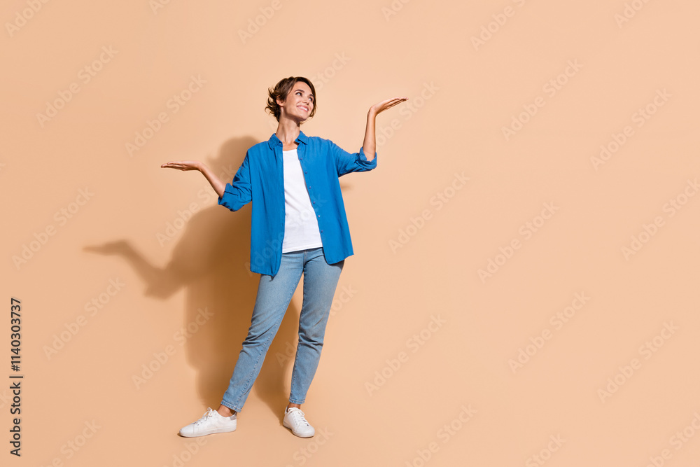 Full body length photo of woman hr manager promoting her company advantages two hands comparison isolated on beige color background Full body length photo of woman hr manager promoting her company advantages two hands comparison isolated on beige color background