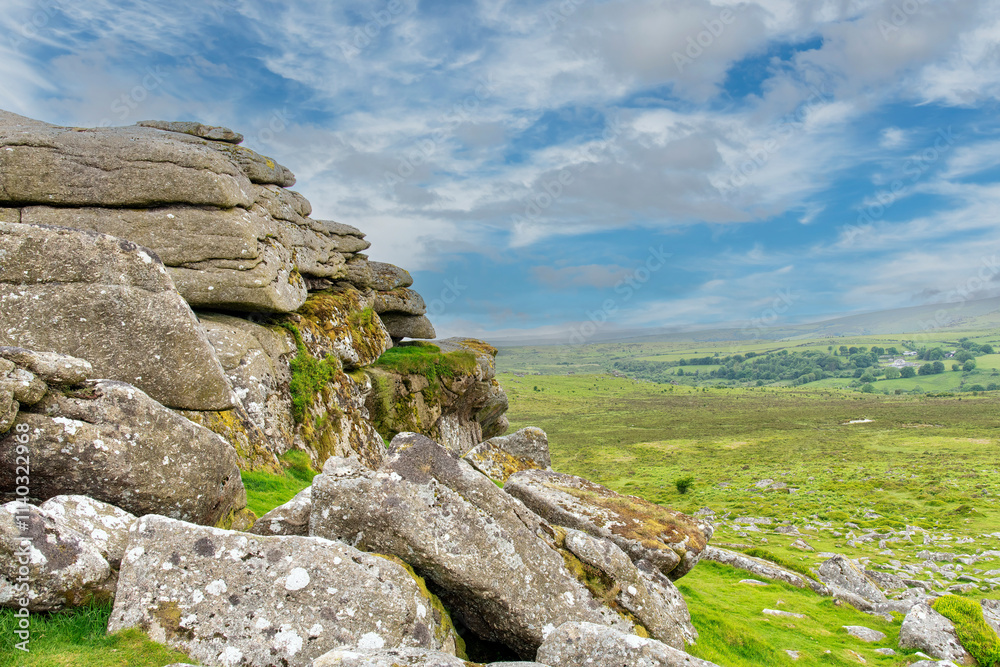 Part of Haytor, Haytor Rocks or Hay Tor granite tor or rock outcrop on the eastern edge of Dartmoor in the English county of Devon, UK with rolling landscape in background Part of Haytor, Haytor Rocks or Hay Tor granite tor or rock outcrop on the eastern edge of Dartmoor in the English county of Devon, UK with rolling landscape in background