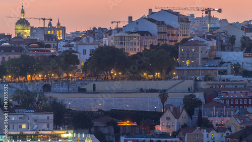 Lisbon panorama after sunset aerial view of city centre with red roofs at autumn day to night timelapse, Portugal
