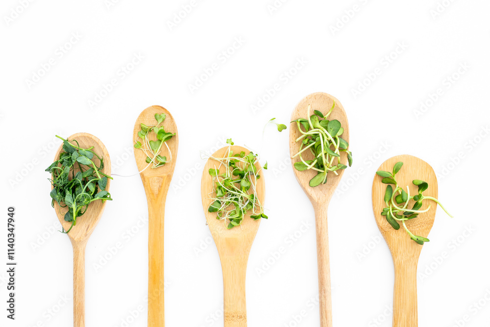 Different kind of microgreens in wooden spoons, top view Different kind of microgreens in wooden spoons, top view