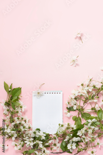 Top view of spring background with notebook on pink banner. Diet plan and healthy eating