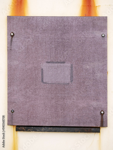 Light purple worn out wooden panel in a window. Aging process. Protecting property from vandals concept. Home security and maintenance.