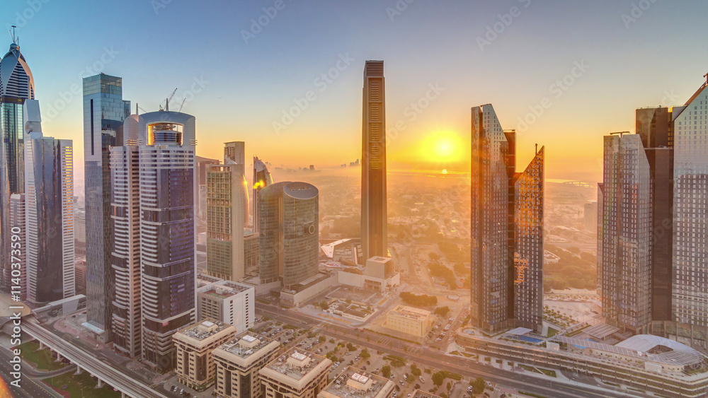 Sunrise over Dubai skyline in the morning, aerial top view to downtown city center landmarks timelapse. Sunrise over Dubai skyline in the morning, aerial top view to downtown city center landmarks timelapse.