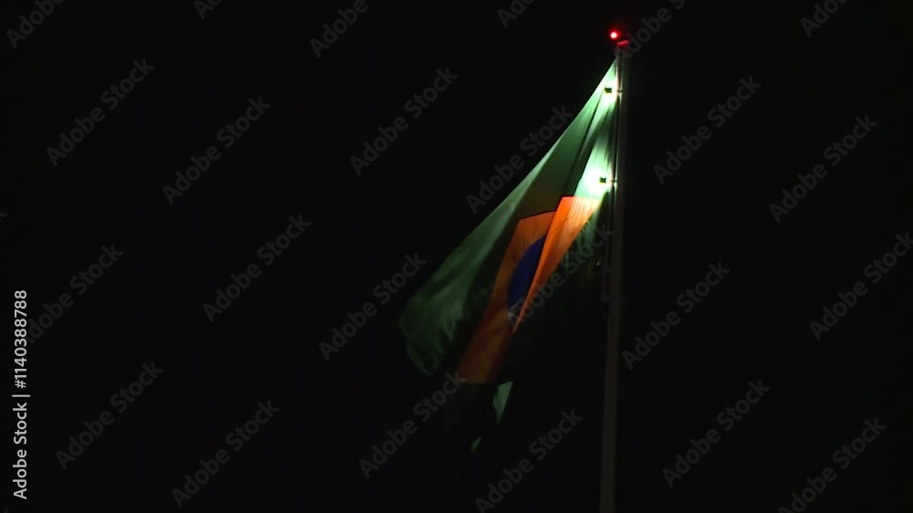 
Brazilian flag fluttering in the darkness, illuminating the Brazilian flag, feeling of nation, sovereignty, Brazilian culture, national symbol