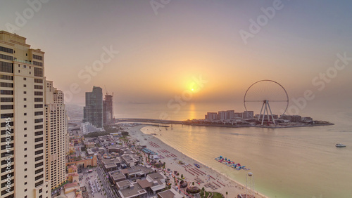 Sunset waterfront overview Jumeirah Beach Residence JBR skyline aerial timelapse with yacht and boats photo