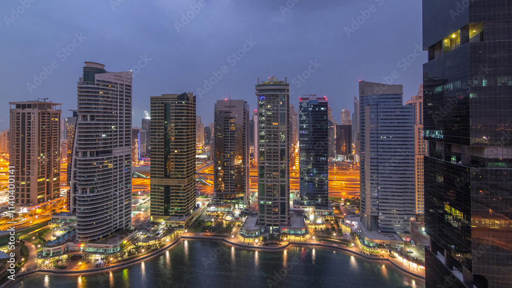 Naklejka premium Residential and office buildings in Jumeirah lake towers district night to day timelapse in Dubai