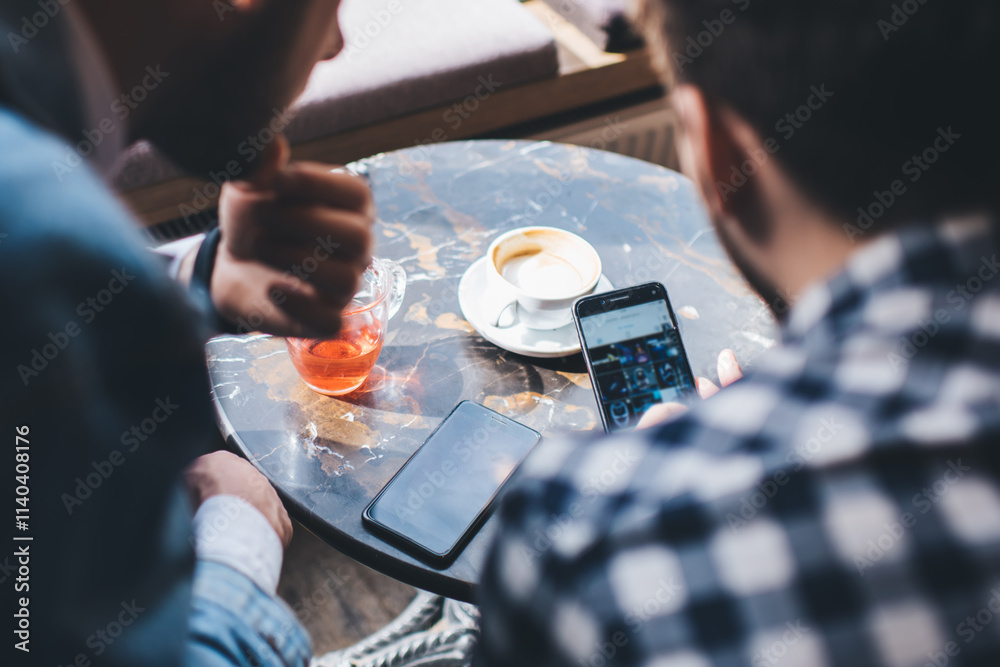 Fotografie Modern male friends using mobile app