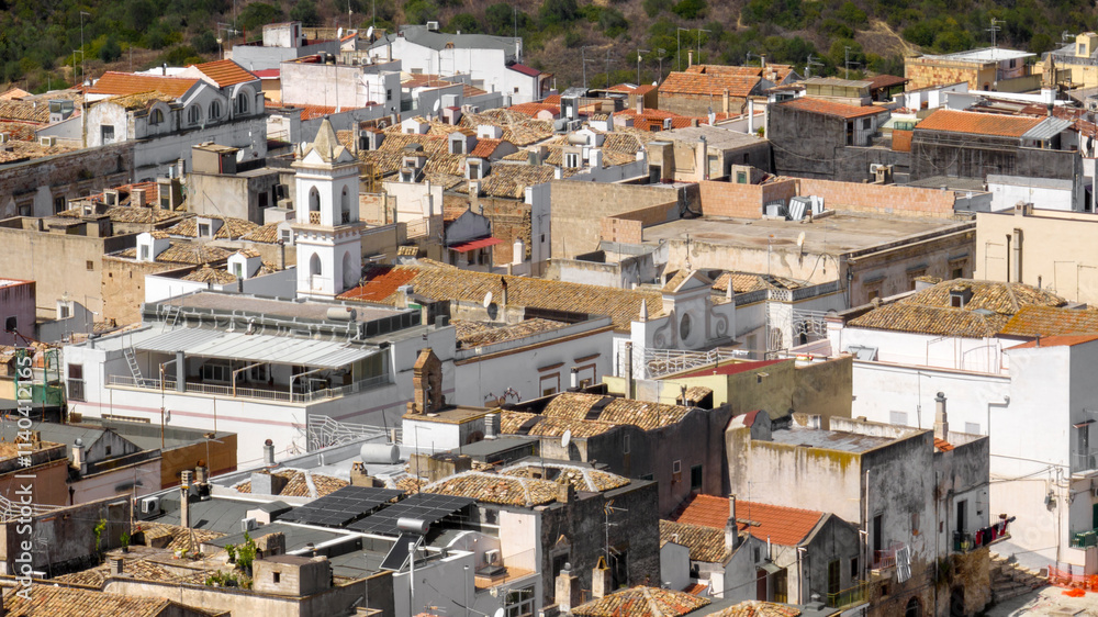 Aerial view of houses, apartments and buildings located in the historic center of the town of Bernalda, in the province of Matera, Basilicata, Italy. It is a traditional Italian village. Aerial view of houses, apartments and buildings located in the historic center of the town of Bernalda, in the province of Matera, Basilicata, Italy. It is a traditional Italian village.