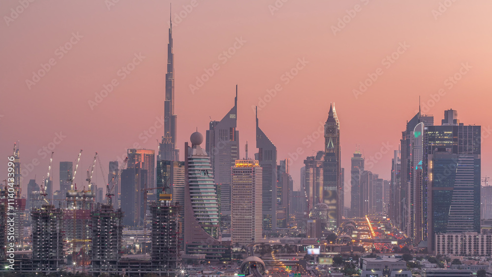 Naklejka premium Dubai skyline after sunset with beautiful city center lights and Sheikh Zayed road traffic timelapse, Dubai, United Arab Emirates