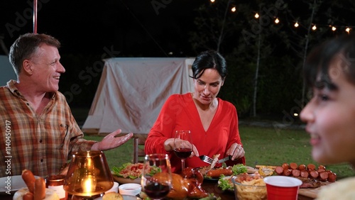 Family gather celebrate holiday. Parents, grandparents and girl together to talk and have dinner party food. Outdoor activity for spending time with multigeneration cross generation gap. Divergence. photo