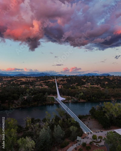 Wallpaper Mural Stunning aerial view of the Sundial Bridge at dusk, with vibrant pink and purple clouds reflecting the fading light over the river and surrounding landscape. Torontodigital.ca