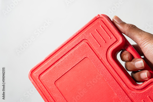 Hand Holding a Red Toolbox