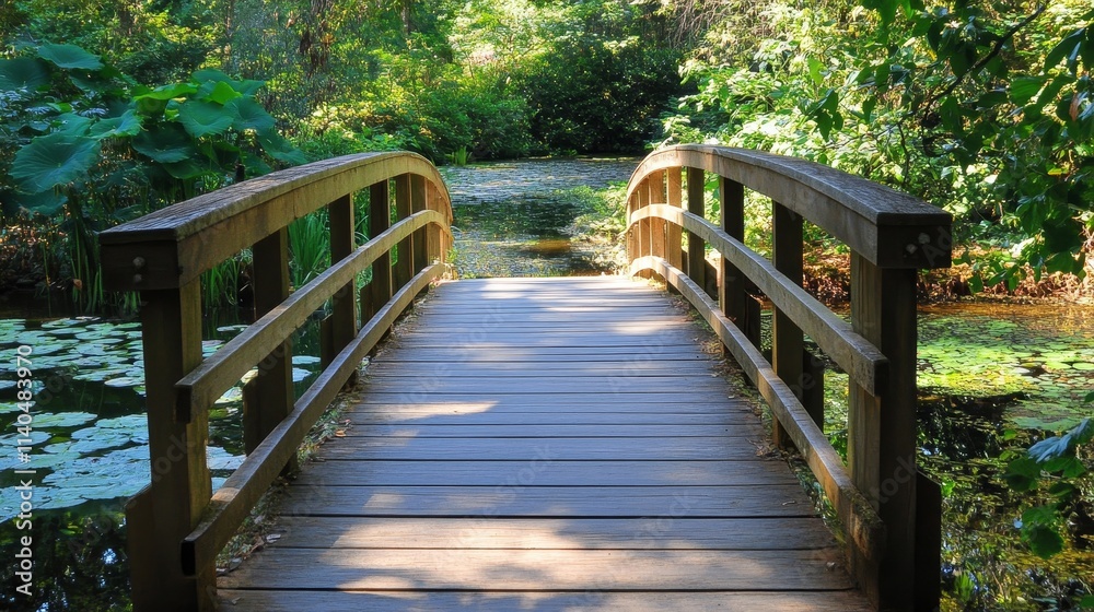 A wooden bridge over a serene pond surrounded by lush greenery. A wooden bridge over a serene pond surrounded by lush greenery.