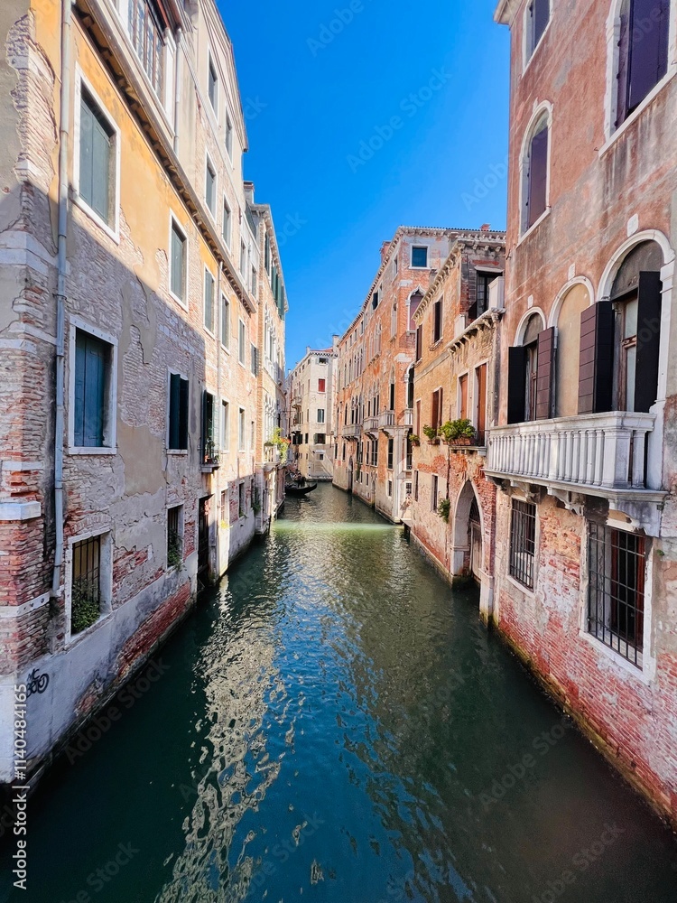Scenic canal view between historic buildings in Venice Italy