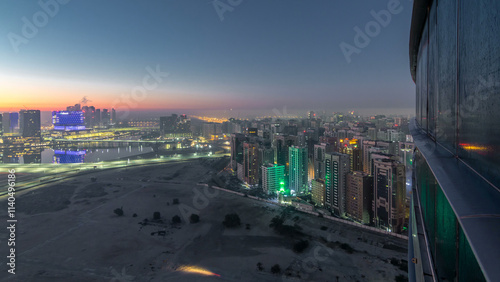 Abu Dhabi city skyline with skyscrapers before sunrise from above night to day timelapse photo