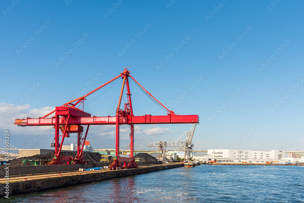 Container port and container crane at Industrial port for cargo container ship Osaka Japan. Business logistic transportation concept. Container port and container crane at Industrial port for cargo container ship Osaka Japan. Business logistic transportation concept.