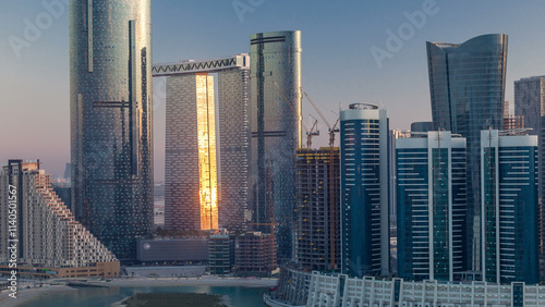 Buildings on Al Reem island in Abu Dhabi timelapse from above. photo