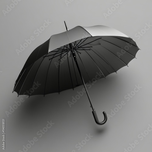 Black umbrella used for protection against rain or sun in various weather con...