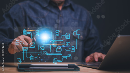 A man is using a laptop to touching a network diagram. Concept of technology and connectivity, as well as the importance of understanding and managing complex systems photo