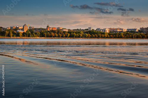 panoramic view of the lake, embankment with silhouettes of the church and cit...
