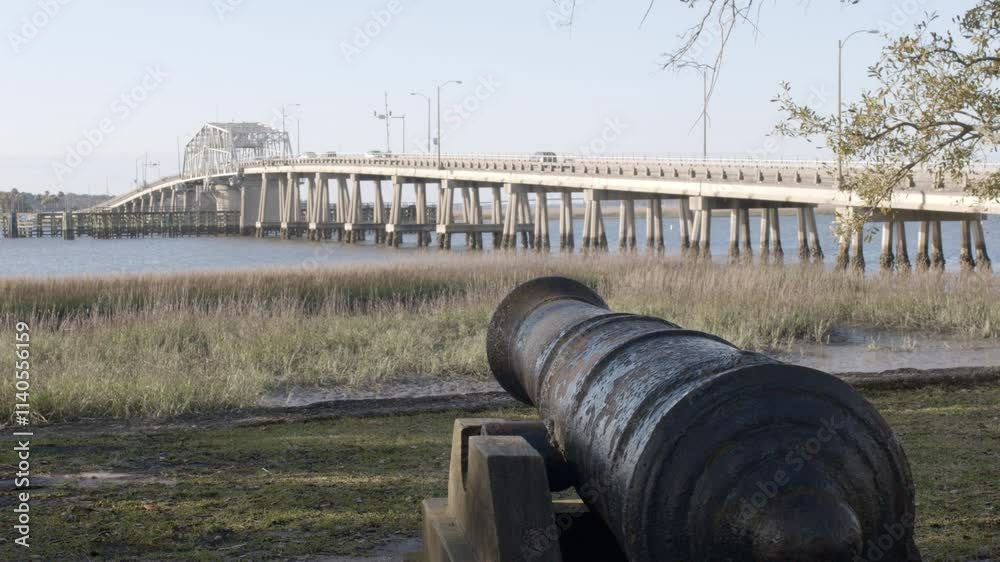 Establishing shot of a park and cannon along the waterfront with the Woods Bridge in the background in Beaufort, South Carolina Establishing shot of a park and cannon along the waterfront with the Woods Bridge in the background in Beaufort, South Carolina
