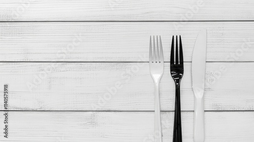 Black and White Fork with Knife on Light Wood Background, Flat Lay Minimalistic Dining or Cooking Concept, Ample Space for Text, High-Quality Professional Photo
