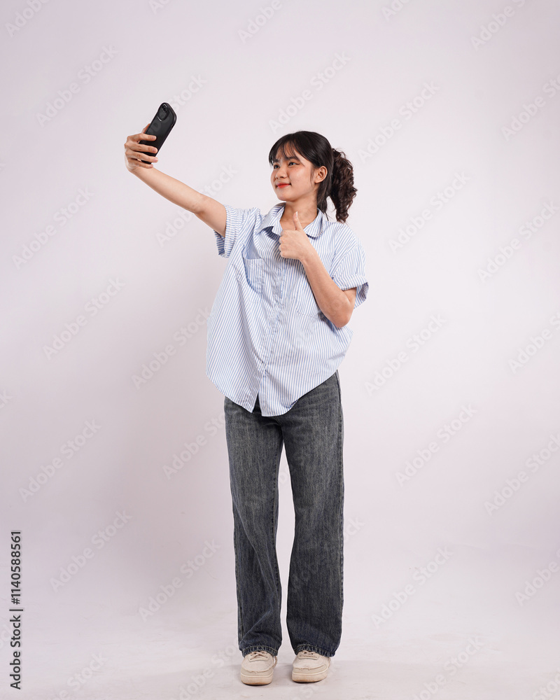 Portrait of beautiful Asian woman posing using phone on white background Portrait of beautiful Asian woman posing using phone on white background
