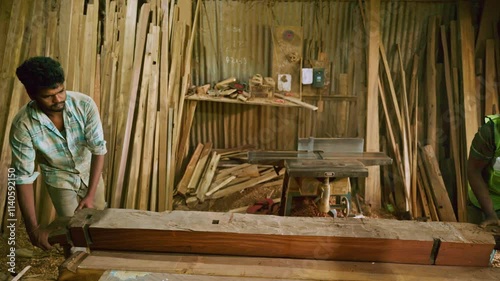 Carpenter smooths wood surface with a Cutter