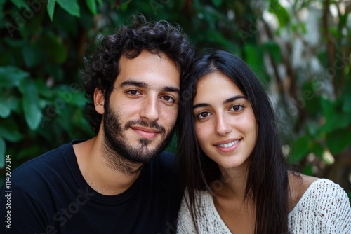 a couple poses together outdoors smiling