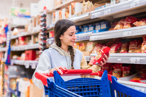 Woman shopping in a supermarket aisle photo