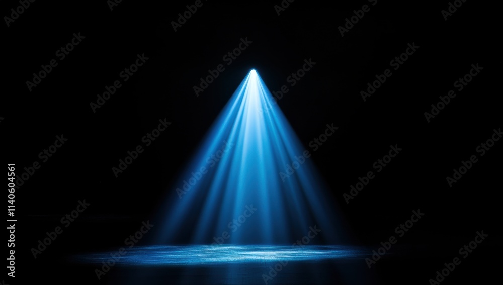 A blue beam of light falls from above the center of an empty black background, illuminating part of it with light and shadow. A blue beam of light falls from above the center of an empty black background, illuminating part of it with light and shadow.