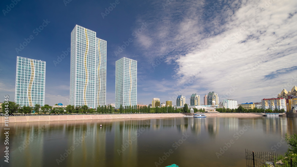 Naklejka premium Ishim River with modern towers of residential complex timelapse hyperlapse in Astana