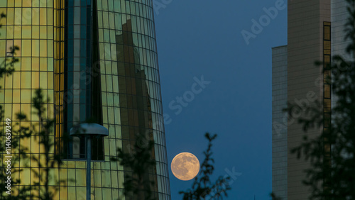 A square in front of Ak Orda with Altyn Orda business center timelapse with full moon. photo