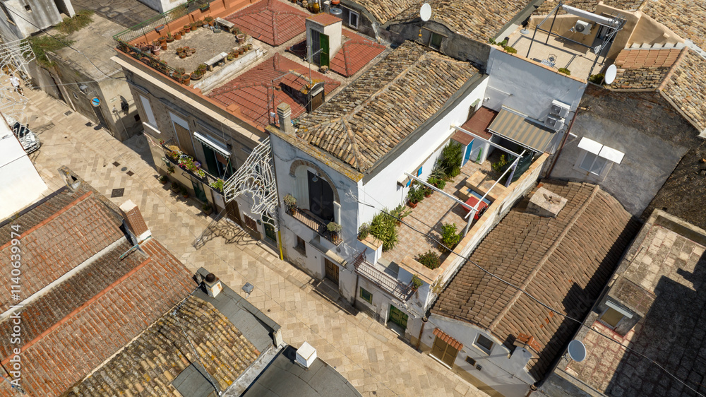 Aerial view of an alley in the historic center of the town of Bernalda, in the province of Matera, Basilicata, Italy. It is a traditional Italian village. Aerial view of an alley in the historic center of the town of Bernalda, in the province of Matera, Basilicata, Italy. It is a traditional Italian village.