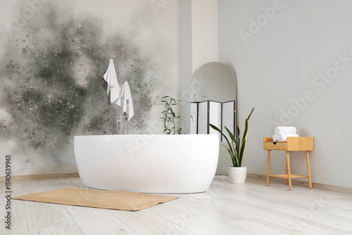 Interior of light room with bathtub, mirror and plants photo